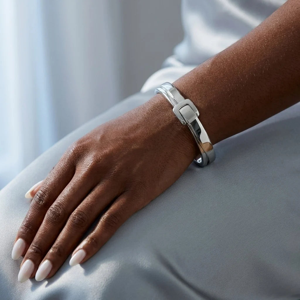 MAYA 01 Antibes buckle cuff in Polished Silver worn on the wrist over pale grey satin