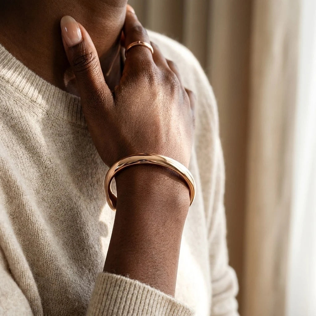 MAYA 01 Cassis rose gold cuff worn with a cream knit