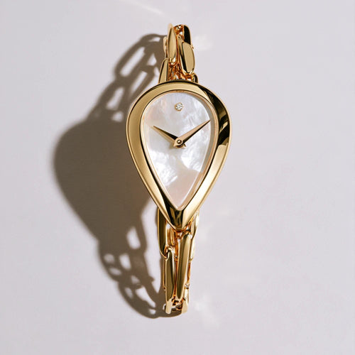 MAYA 01 Celeste gold teardrop watch with a pearly white dial and a single stone at twelve