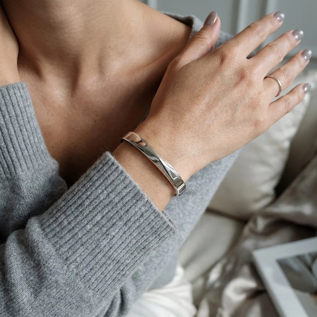 MAYA 01 Mykonos silver cuff worn with a grey knit