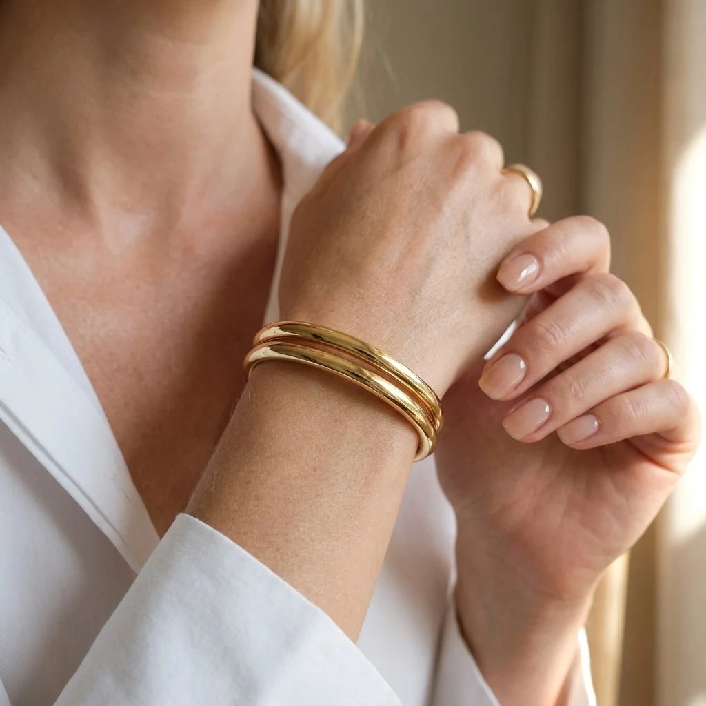 MAYA 01 Ravello double band cuff in Polished Gold worn with a crisp white shirt and gold rings