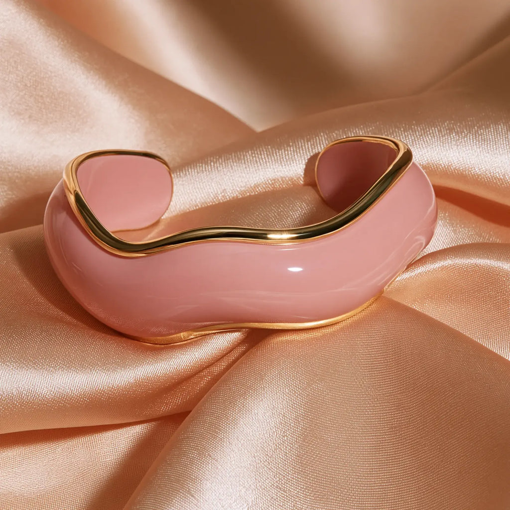 MAYA 01 Saint-Tropez wide wave cuff in Petal Pink, glossy pink edged with gold rims, on peach satin